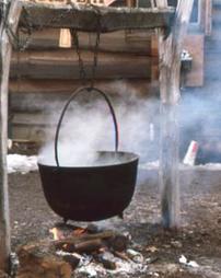 Steaming Hanging Iron Kettle Over Fire