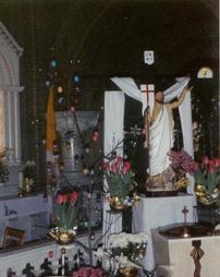 Christ Statue, flowers, and Cross at Sts. Casimir and Emerich Church