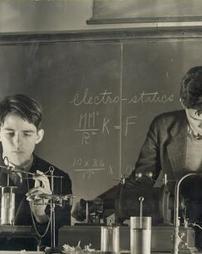 Two boys in science classroom laboratory, 1938
