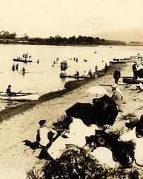 Beach scene around the turn of the twentieth century: sunbathing, canoeing