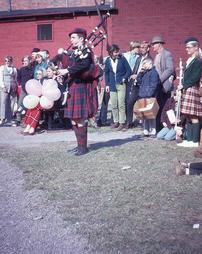 Crowd Behind Performing Bagpiper at Maple Festival