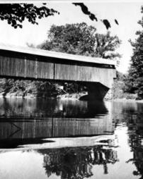 Covered wood bridge over creek