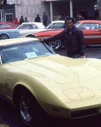 Man Poses at Yellow Corvette at Maple Festival Car Show