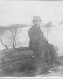 Man on log in the winter