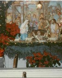 Nativity scene with poinsettias and garland at Sts. Casimir and Emerich Church