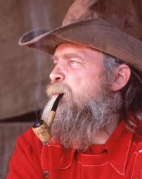 Man in Cowboy Hat Smoking Pipe