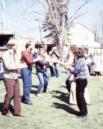 Two Lines of Square Dancers With Crowd on Lawn