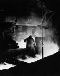 Man casting at a blast furnace 