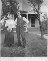 Man and woman standing in front yard