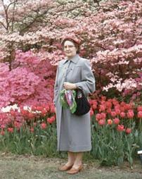 Lady posing with tulips and dogwoods.