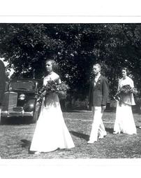 Graduation procession with car in the background, 1938