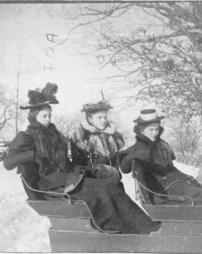 Three women in a sleigh near Hostetler's