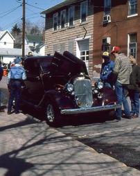 People Looking at Dark Red Antique Car at Car Show