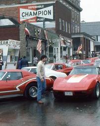 Man looking at Red Corvette at Maple Festival Car Show