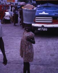 Girl carrying bucket of supplies