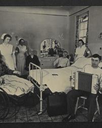 Group of nurses and patients gathered in a patient's hospital room