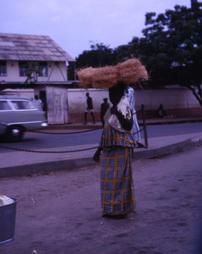 Woman carrying straw