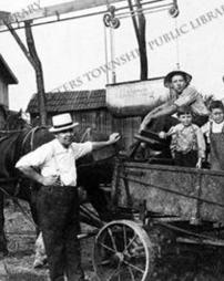 Boys in horse-drawn wagon, circa 1917.