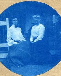 Unidentified women seated on porch steps