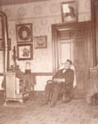 John S. Duss sitting in rocking chair, Rapp House interior