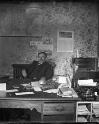 James M. Cover at his desk