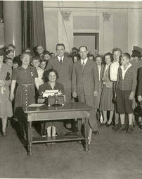 Typist among a group, largely women, in the Williamsport High School auditorium