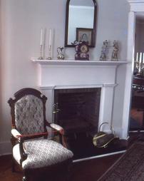 Upholstered Chair at Fireplace in Maple Manor