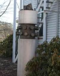 Cylindrical concrete and metal sculpture