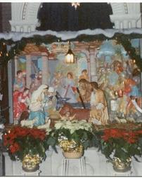 Nativity scene with poinsettias and garland at Sts. Casimir and Emerich Church