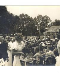 Graduation procession with school buildings in background, 1938