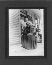 Mother McMurray and daughter stop for a picture on front porch