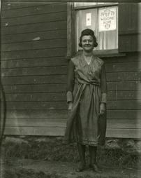 Woman stands by window with blue star