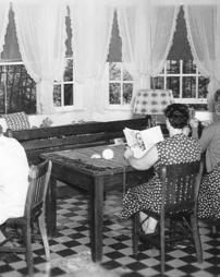 Inmates reading and sewing in the sunroom of Newman Cottage at the State Industrial Home for Women at Muncy, PA