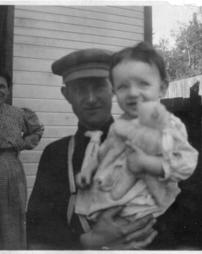 Man holding baby with teddy bear