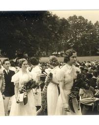 Graduating class walks through daisy chain, 1938