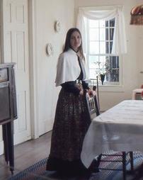 Girl Stands at Dining Table at Maple Manor