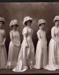 Five women in white dresses