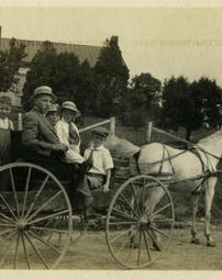 Individuals on horse-drawn carriage.