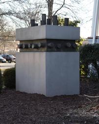 Cube shaped concrete and metal sculpture