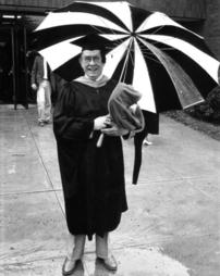 Professor Hollenback Poses With Umbrella, Commencement 1987