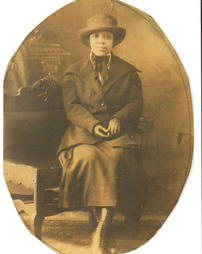 Women seated in coat and gloves
