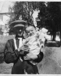 Man with baby holding bear