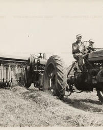 Earl Froebe driving a tractor.
