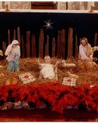 Nativity scene with poinsettias at Sts. Casimir and Emerich Church