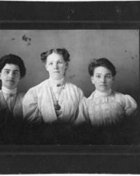 Three girls standing shoulder to shoulder