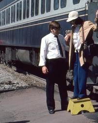 Man Helps Woman Disembarking Train