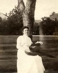 Portrait of unidentified woman seated on bench
