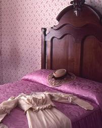 Dress and Hat on Bed in Maple Manor
