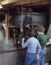 Group in Front of Maple Sugar Camp Evaporator at Maple Festival Park