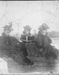 Three ladies on a sleigh